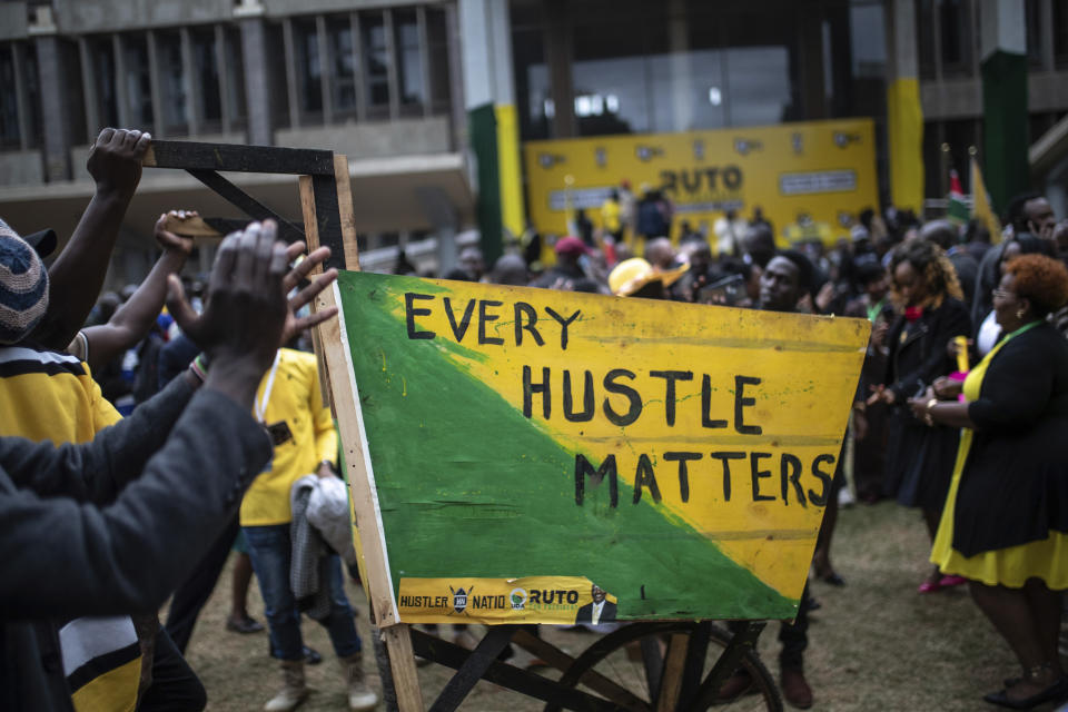 Supporters of Kenyan Deputy President William Ruto push a wheelbarrow, a symbol used by the United Democratic Alliance (UDA) party, as they celebrate at his party headquarters in Nairobi, Kenya, Monday, Aug. 15, 2022. Kenya's electoral commission chairman has declared Deputy President William Ruto the winner of the close presidential election over five-time contender Raila Odinga, a triumph for the man who shook up politics by appealing to struggling Kenyans on economic terms and not on traditional ethnic ones. (AP Photo/Mosa'ab Elshamy)