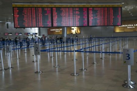 A board listing flight schedules is seen at Ben Gurion International airport, near Tel Aviv July 24, 2014. REUTERS/Baz Ratner