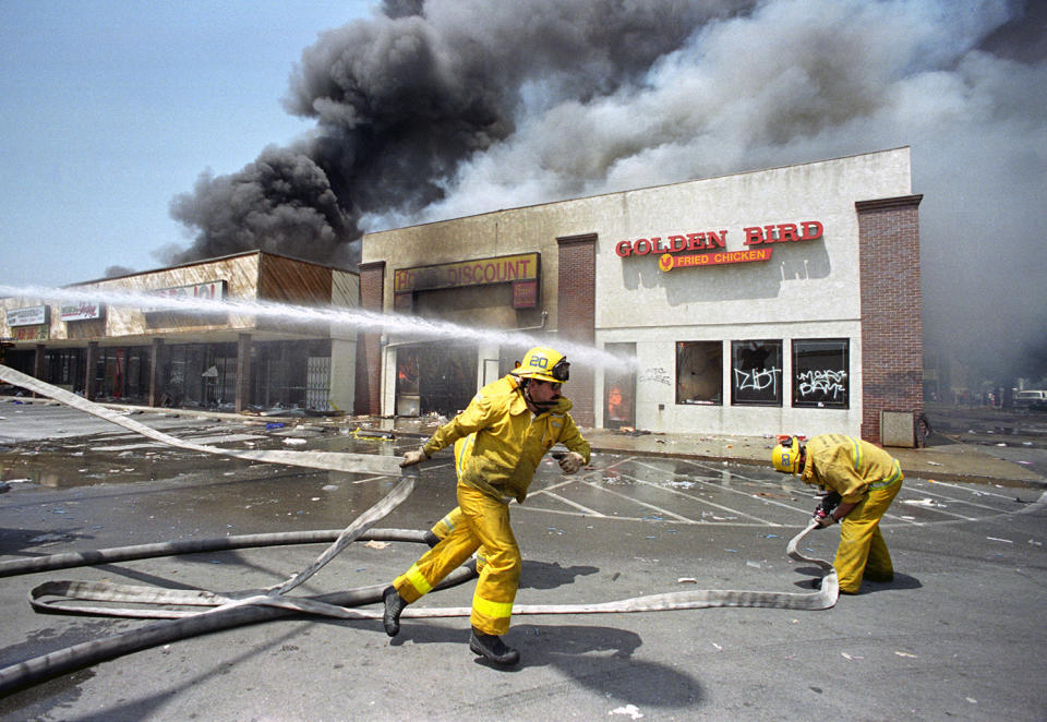 Firefighters battle blaze in group of stores