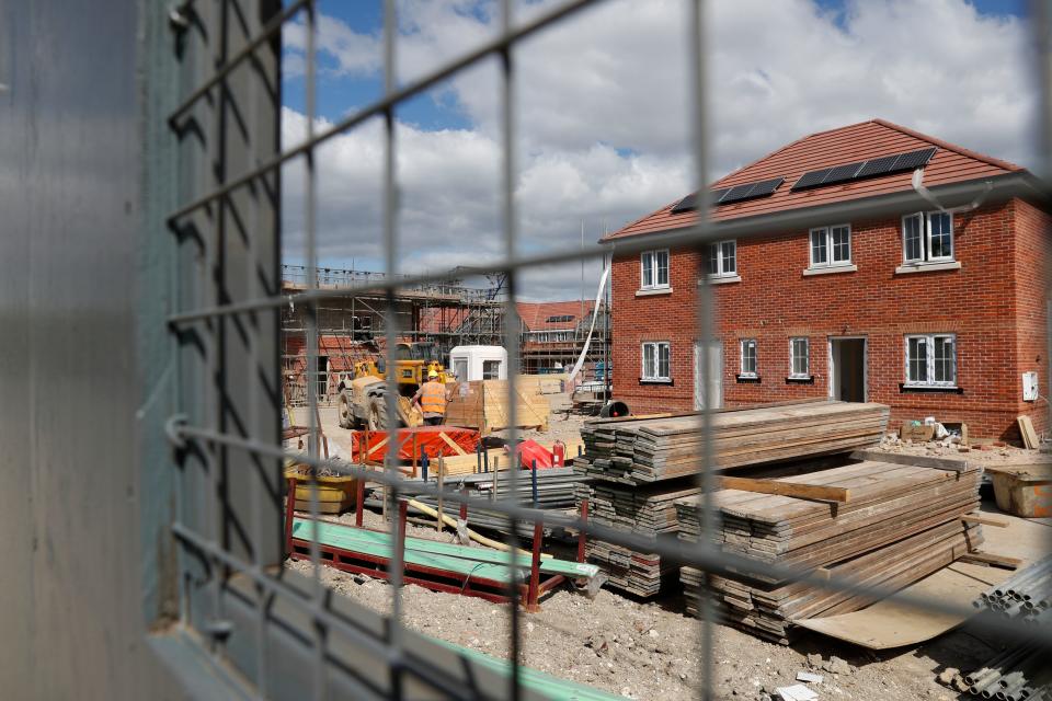 Workers are s seen on a construction site near Guildford, southwest of London