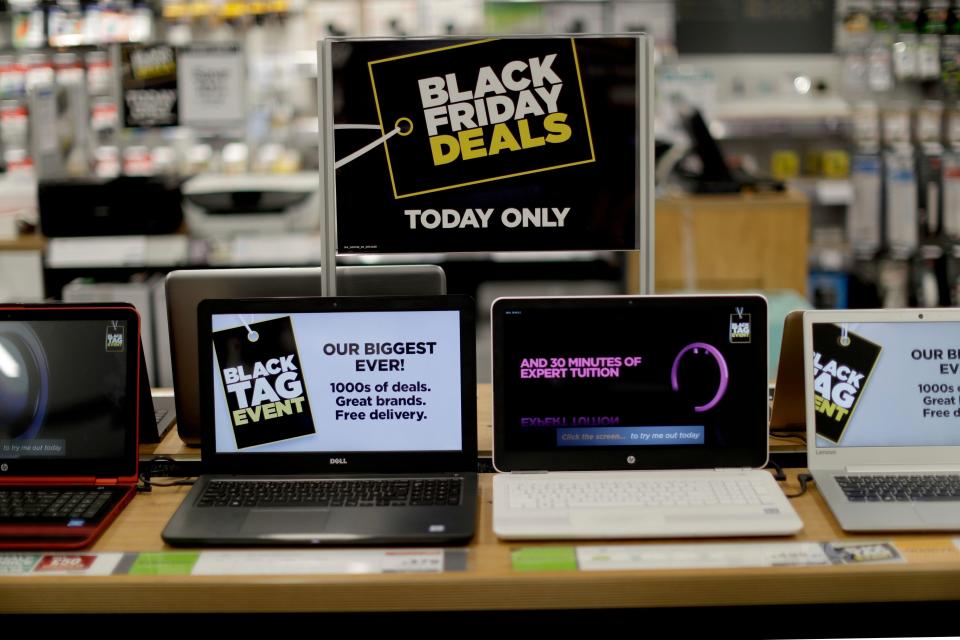 A Black Friday Deals sign is displayed above laptops during early morning Black Friday sales in a branch of an electrical retailer on Oxford Street in London, Friday, Nov. 25, 2016. Many Black Friday discount purchases were being carried out online in 2016, as bargain hunters made a technological shift from the traditional early morning queues waiting for retail outlets to open their doors. (AP Photo/Matt Dunham)