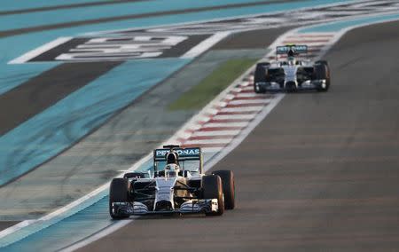 Mercedes Formula One driver Lewis Hamilton of Britain drives ahead of teammate Nico Rosberg of Germany during the Abu Dhabi F1 Grand Prix at the Yas Marina circuit in Abu Dhabi November 23, 2014. REUTERS/Ahmed Jadallah