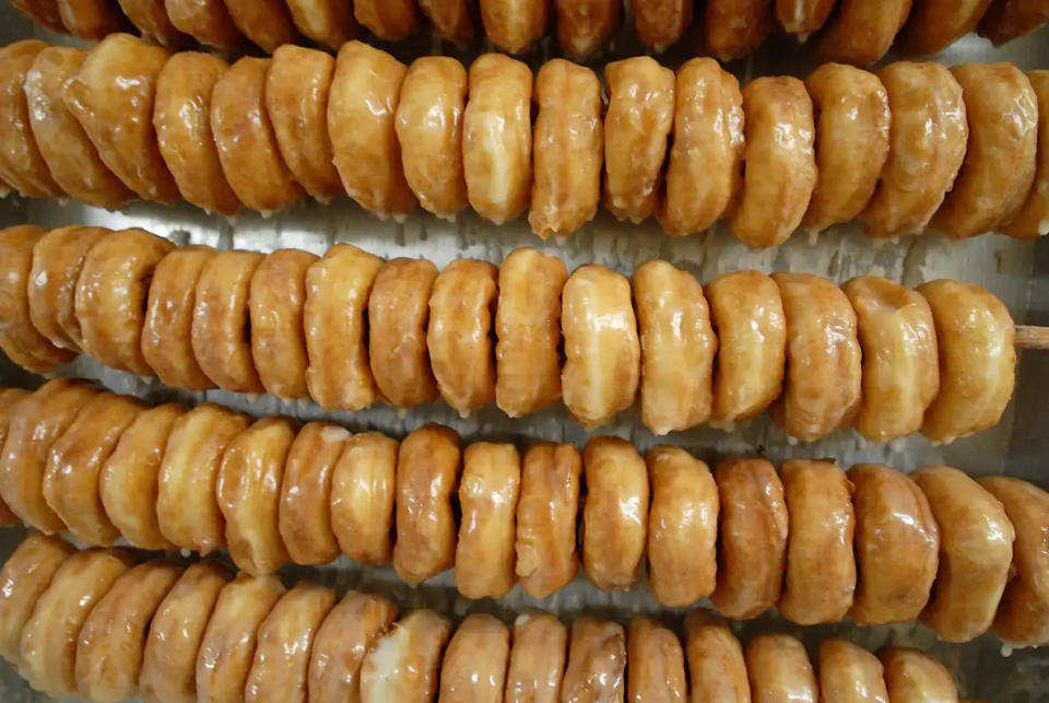 Five racks of recently glazed donuts dry at Britt's Donut Shop at Carolina Beach on Saturday, July 21, 2007.