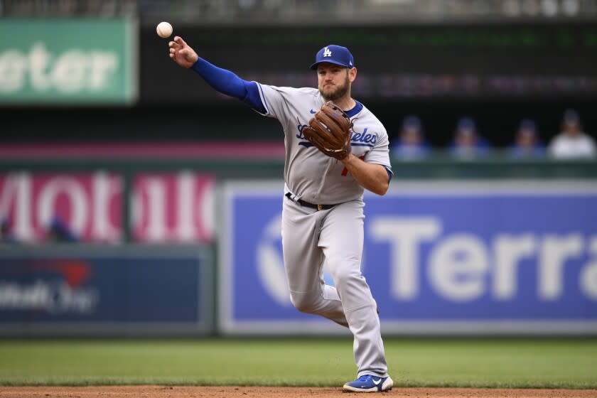 Los Angeles Dodgers second baseman Max Muncy throws to first.