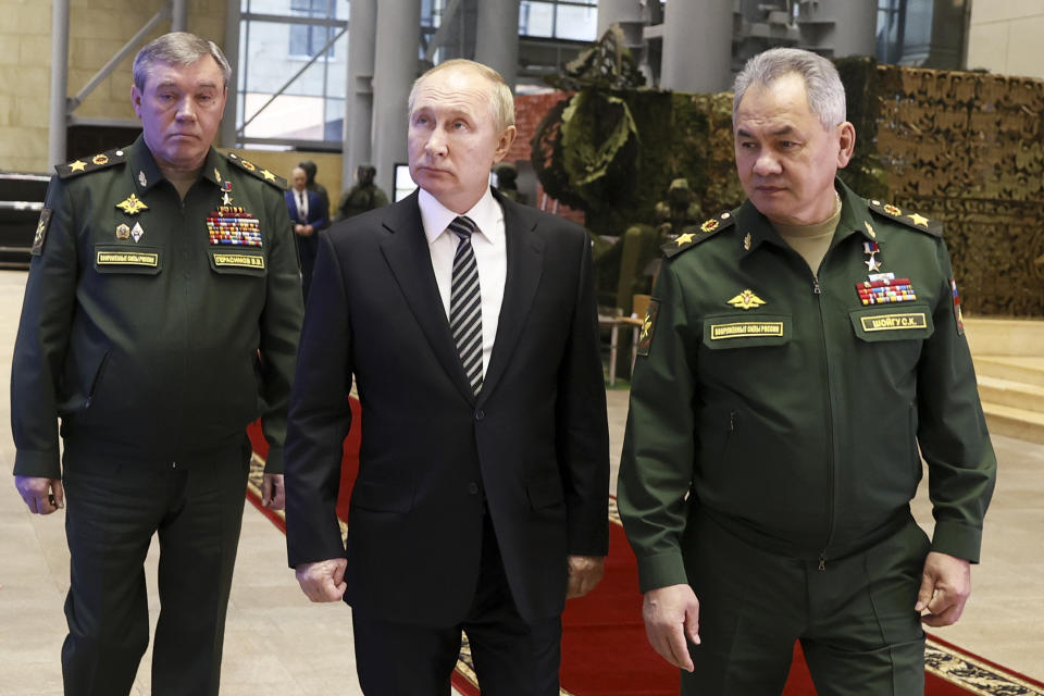 FILE - Russian President Vladimir Putin, center, escorted by Russian Defense Minister Sergei Shoigu, right, and General Staff Valery Gerasimov walk after attending an extended meeting of the Russian Defense Ministry Board at the National Defense Control Center in Moscow, Russia, Tuesday, Dec. 21, 2021. As Russian troops wage a ferocious house-to-house fight for control of strongholds in eastern Ukraine, a parallel battle is unfolding in the top echelons of military power in Moscow, with President Vladimir Putin reshuffling his top generals while rival camps try to win his favor. (Mikhail Metzel, Sputnik, Kremlin Pool Photo via AP, File)