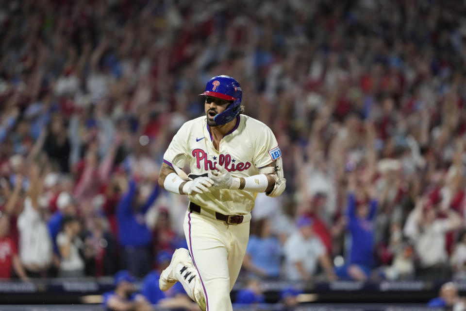 Philadelphia Phillies' Nick Castellanos reacts after hitting a one-run single against New York Mets pitcher Tylor Megill during the ninth inning to win Game 2 of a baseball NL Division Series, Sunday, Oct. 6, 2024, in Philadelphia. (AP Photo/Matt Slocum)