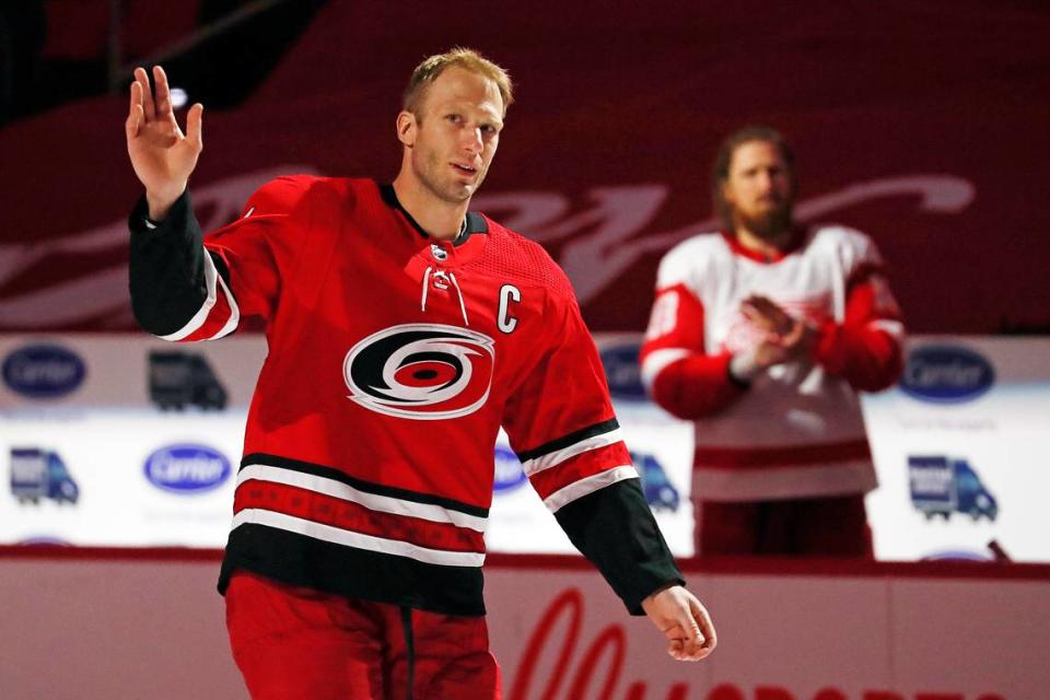 Carolina Hurricanes Jordan Staal (11) salutes the crowd with his brother Detroit Red Wings’ Marc Staal (18) during a pre-game ceremony recognizing his 1000 career game prior to the first period of an NHL hockey game between the Carolina Hurricanes and the Detroit Red Wings in Raleigh, N.C., Monday, April 12, 2021. (AP Photo/Karl B DeBlaker)