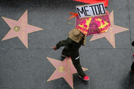 FILE PHOTO: A demonstrator takes part in a #MeToo protest march for survivors of sexual assault and their supporters in Hollywood, Los Angeles, California U.S. November 12, 2017. REUTERS/Lucy Nicholson/File Photo