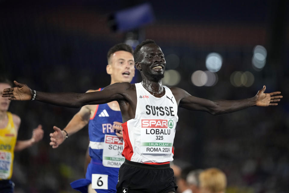 Dominic Lokinyomo Lobalu, of Switzerland, crosses the finish line to win the men's 10000 meters A-race at the European Athletics Championships in Rome, Wednesday, June 12, 2024. (AP Photo/Stefano Costantino)