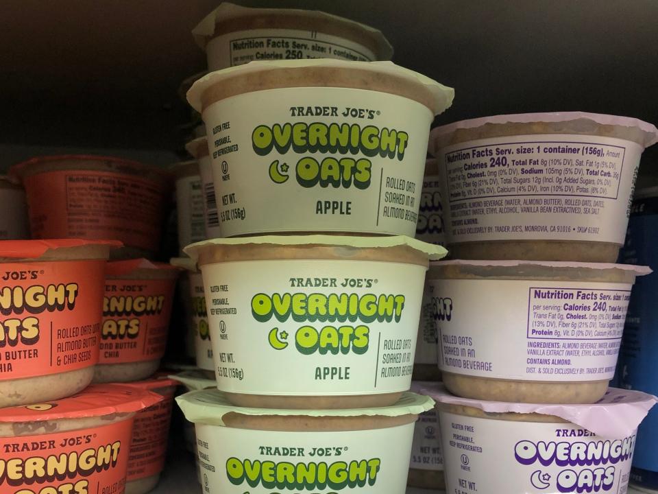 Stacks of different flavors of overnight oats on display at Trader Joes, with price tags that read $1.99.