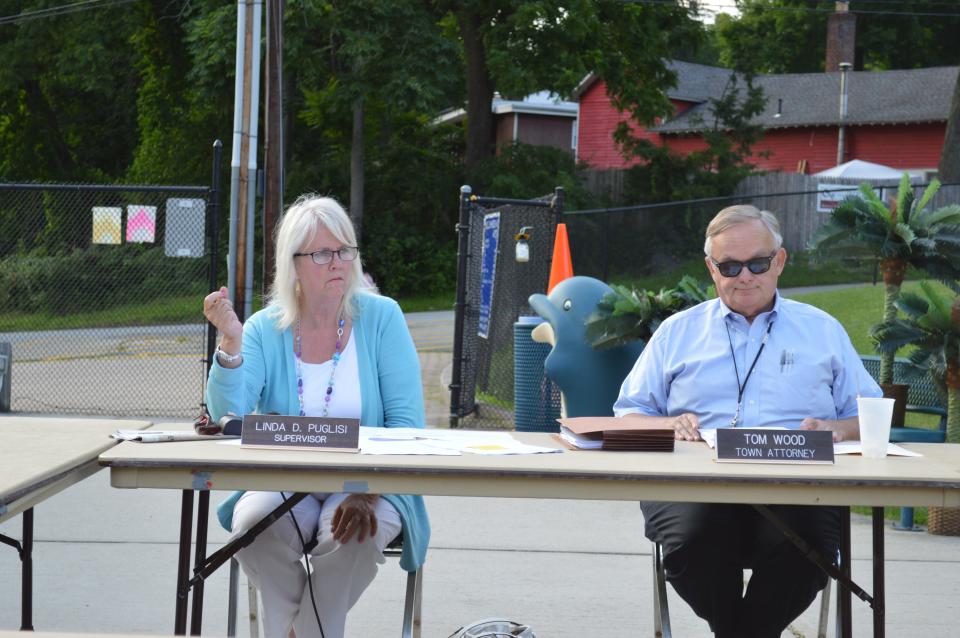 Cortlandt Town Supervisor Linda Puglisi, left, and Town Attorney Tom Wood, center, discuss the town's tax-foreclosure auction on at a town board meeting held at the town pool on Furnace Dock Road in July, 2014.