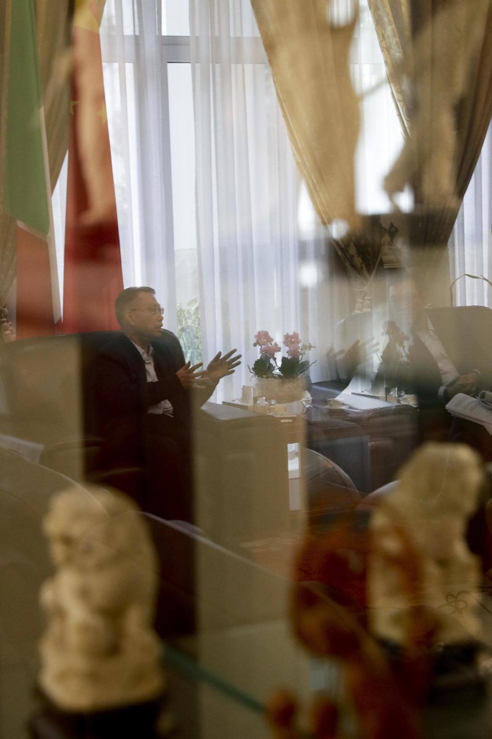 Professor Huang Jiefu, Chairman of the Chinese National Organ Donation and Transplantation Committee, is seen through a window during an interview with The Associated Press, at the Chinese embassy to Italy, in Rome, Monday, Feb. 6, 2017. China is stepping up its efforts to convince the international medical community that it has stopped using executed prisoners as organ donors. (AP Photo/Andrew Medichini)