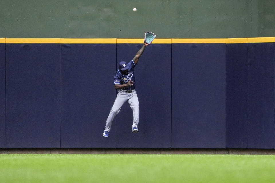 Tampa Bay Rays' Randy Arozarena can't make the catch at the wall on a home run by Milwaukee Brewers' Willy Adames during the seventh inning of a baseball game Wednesday, May 1, 2024, in Milwaukee. (AP Photo/Kenny Yoo)