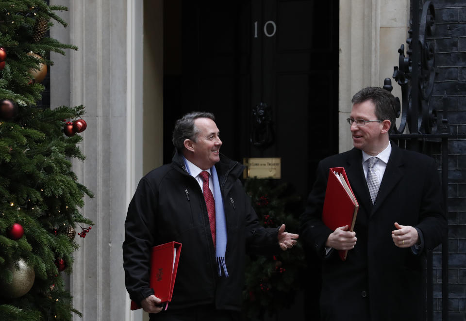 Liam Fox Secretary of State for International Trade, left with Jeremy Wright the Secretary of State for Culture leave following a cabinet meeting at 10 Downing Street, in London Tuesday, Dec. 18, 2018. (AP Photo/Alastair Grant)