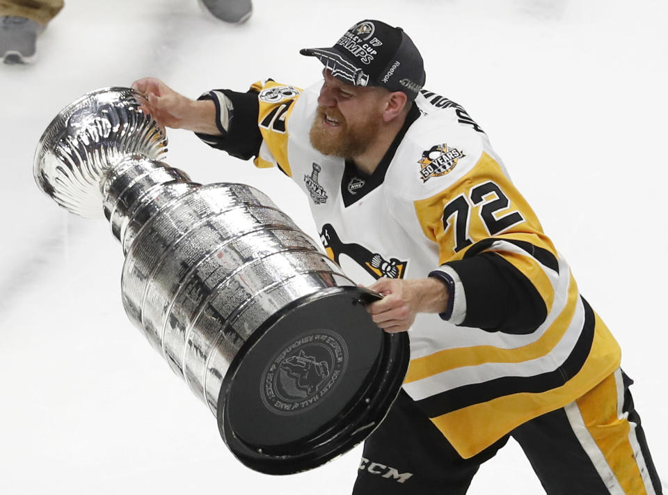 FILE - In this June 11, 2017, file photo, Pittsburgh Penguins' Patric Hornqvist (72), of Sweden, hoists the Stanley Cup after defeating Nashville Predators in Game 6 of the NHL hockey Stanley Cup Final in Nashville, Tenn. The past few weeks have seen several recent Stanley Cup winners get rid of members of their championship core. The Chicago Blackhawks moved on from Corey Crawford, the Washington Capitals did the same with Braden Holtby, the Pittsburgh Penguins traded fellow goalie Matt Murray and forward Patric Hornqvist and the St. Louis Blues signing Torey Krug means captain Alex Pietrangelo will sign elsewhere. (AP Photo/Jeff Roberson, File)