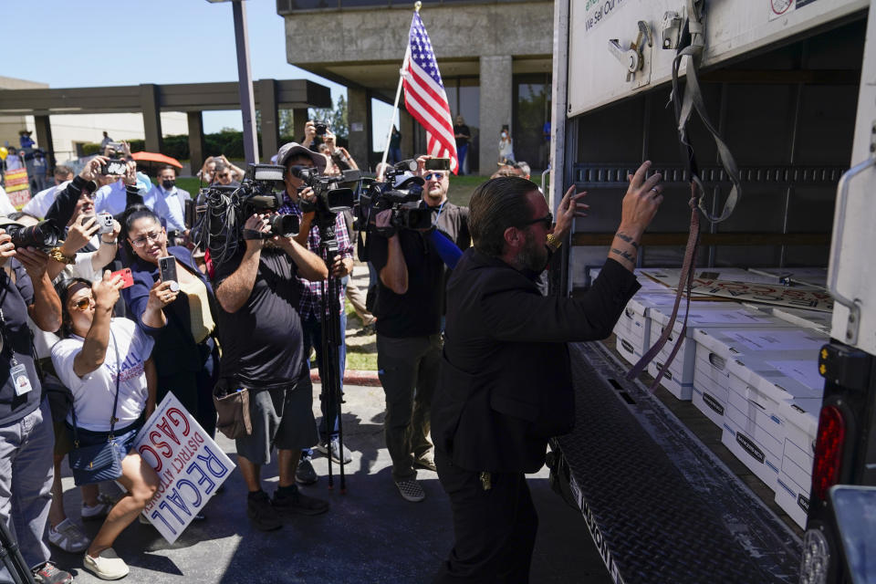 Supporters of a campaign to recall Los Angeles County District Attorney George Gascon gather to view a truck full of petitions outside the Los Angeles County Registrar of Voters on Wednesday, July 6, 2022, in Norwalk, Calif. (AP Photo/Ashley Landis)