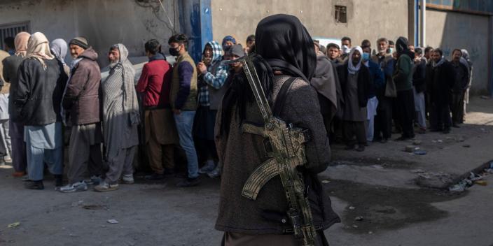 People queue to receive cash in Kabul, Afghanistan.