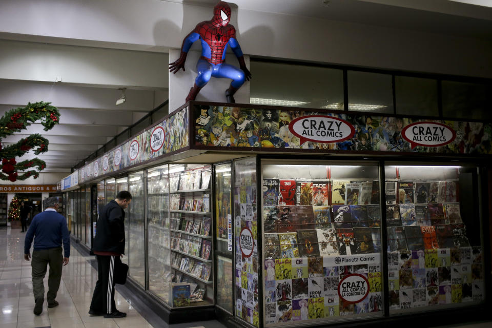 In this Nov. 12, 2018 photo, a life size Spiderman figure looms over the display window of a comic store in Santiago, Chile. Comic book genius Stan Lee, the architect of the contemporary comic book, has died. The creative dynamo who revolutionized the comics by introducing human frailties in superheroes such as Spider-Man, The Fantastic Four and The Incredible Hulk, was declared dead Monday, Nov. 12, 2018, at Cedars-Sinai Medical Center in Los Angeles, according to Kirk Schenck, an attorney for Lee's daughter, J.C. Lee. (AP Photo/Esteban Felix)