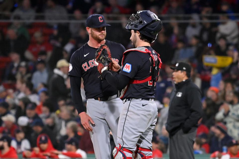 Cleveland Guardians catcher Austin Hedges (27) talks to starting pitcher Ben Lively (39) in a game against the Boston Red Sox on April 17 in Boston.