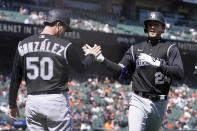 Colorado Rockies' Ryan McMahon, right, celebrates after hitting a two-run home run that also scored Chi Chi Gonzalez (50) during the fifth inning of a baseball game against the San Francisco Giants in San Francisco, Saturday, April 10, 2021. (AP Photo/Jeff Chiu)