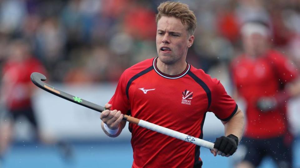 Gareth Furlong runs with his hockey stick