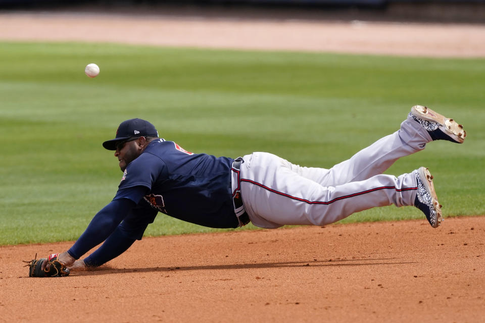 Atlanta Braves first baseman Pablo Sandoval can't reach a ball hit for a single by Tampa Bay Rays' Willy Adames in the fifth inning of a spring training baseball game Sunday, March 21, 2021, in Port Charlotte, Fla. (AP Photo/John Bazemore)