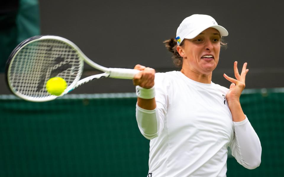 Iga Swiatek of Poland in action against Lin Zhu of China in the first round during Day One of The Championships Wimbledon 2023 at All England Lawn Tennis and Croquet Club on July 03, 2023