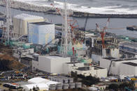 FILE - This March 11, 2012, file photo, shows three melted reactors, from left, Unit 1, Unit 2 and Unit 3 at Fukushima Dai-ichi nuclear power plant in Okuma, Fukushima prefecture, Japan. Japan revised a roadmap on Friday, Dec. 27, 2019, for the tsunami-wrecked Fukushima nuclear plant cleanup, further delaying the removal of thousands of spent fuel units that remain in cooling pools since the 2011 disaster. (Kyodo News via AP, File)
