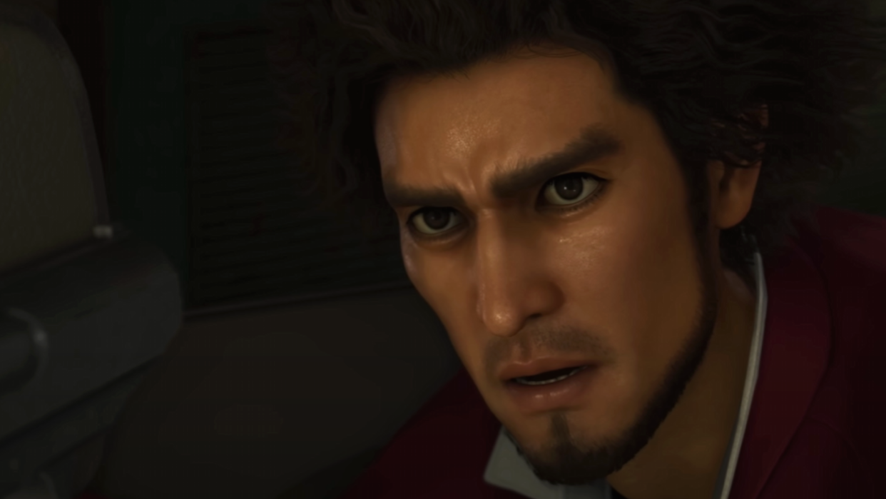  Ichiban, a character in Like a Dragon: Infinite Wealth with curly hair and manly stubble, looks up, shocked, at the viewer. 