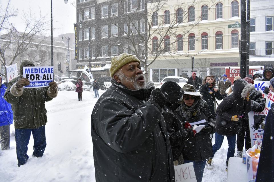 Dohald Bell, of Chicago, speaks at a protest over the proposed health care law in downtown Racine, Wis., on Tuesday, March 14, 2017. A few hundred protesters gathered near House Speaker Paul Ryan's Racine office to protest the American Health Care Act. (Mark Schaaf/The Journal Times via AP) /The Journal Times via AP)