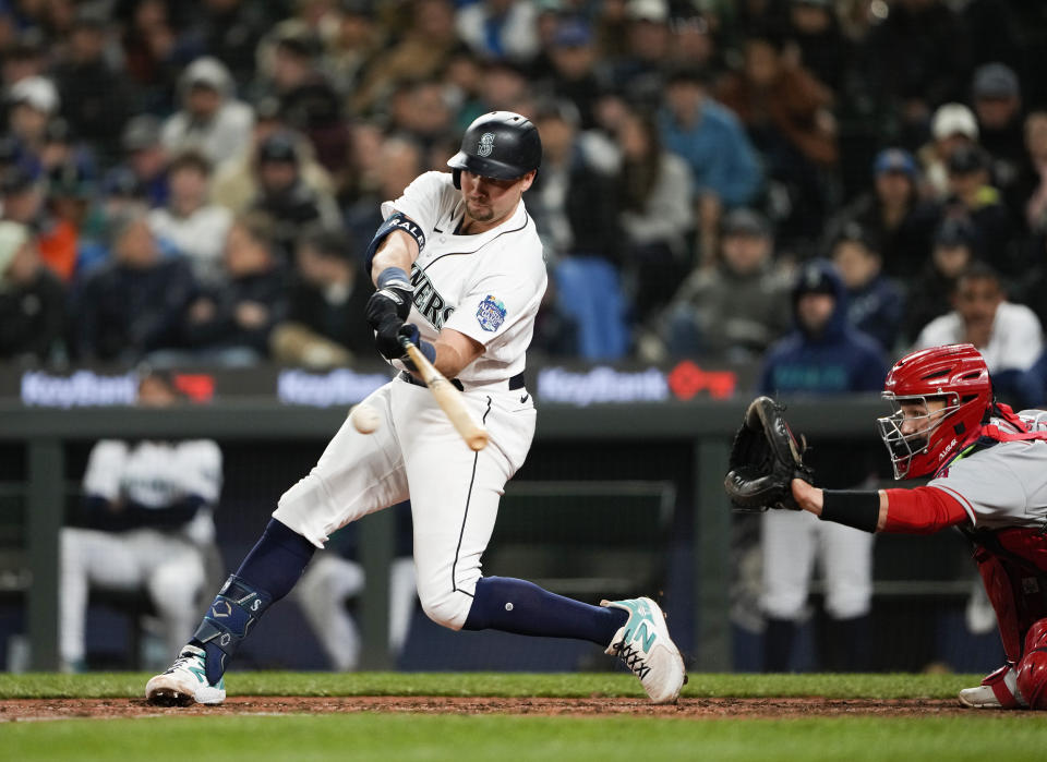 Seattle Mariners' Cal Raleigh hits an RBI single against the Los Angeles Angels during the seventh inning of a baseball game Tuesday, April 4, 2023, in Seattle. (AP Photo/Lindsey Wasson)