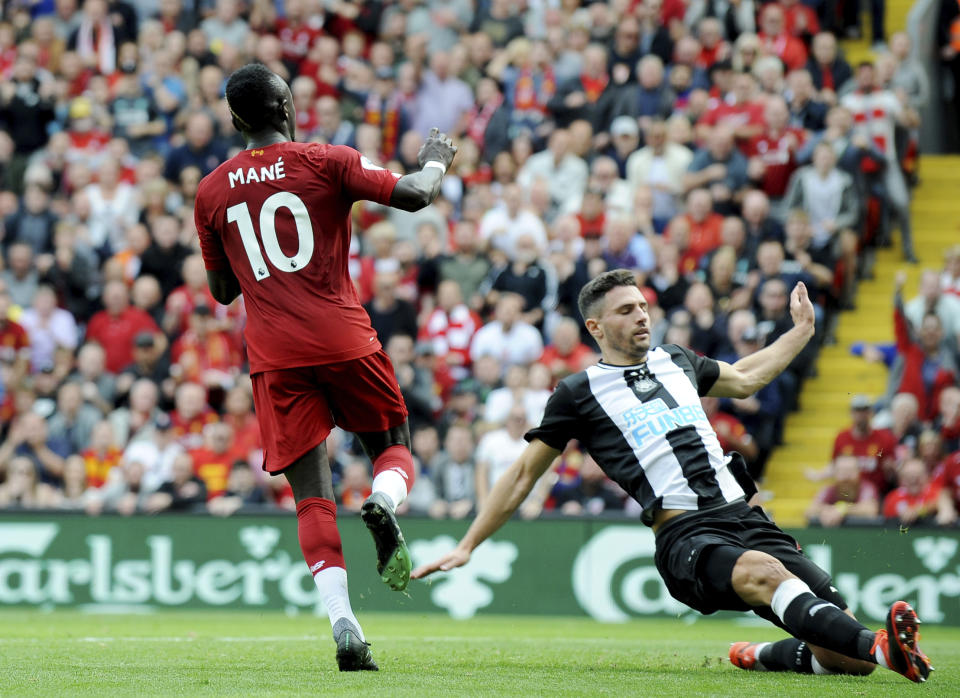 Liverpool's Sadio Mane, left, after scoring his sides second goal during the English Premier League soccer match between Liverpool and Newcastle at Anfield stadium in Liverpool, England, Saturday, Sept. 14, 2019. (AP Photo/Rui Vieira)