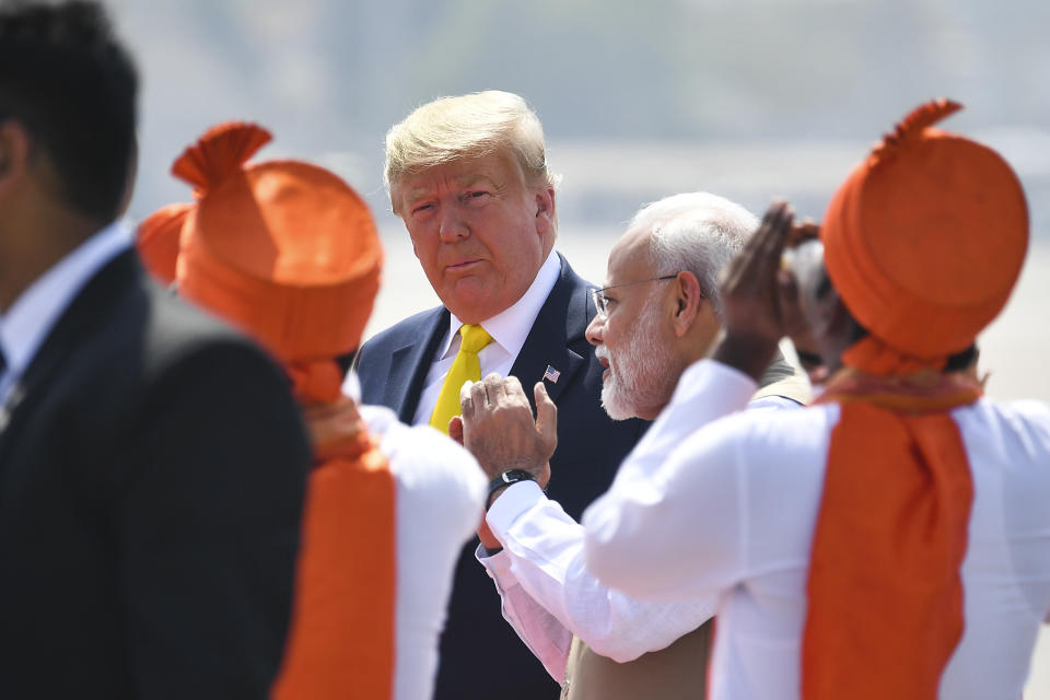 India's Prime Minister Narendra Modi (R) speaks with US President Donald Trump (C) upon his arrival at Sardar Vallabhbhai Patel International Airport in Ahmedabad on February 24, 2020. (Photo by MANDEL NGAN / AFP) (Photo by MANDEL NGAN/AFP via Getty Images)