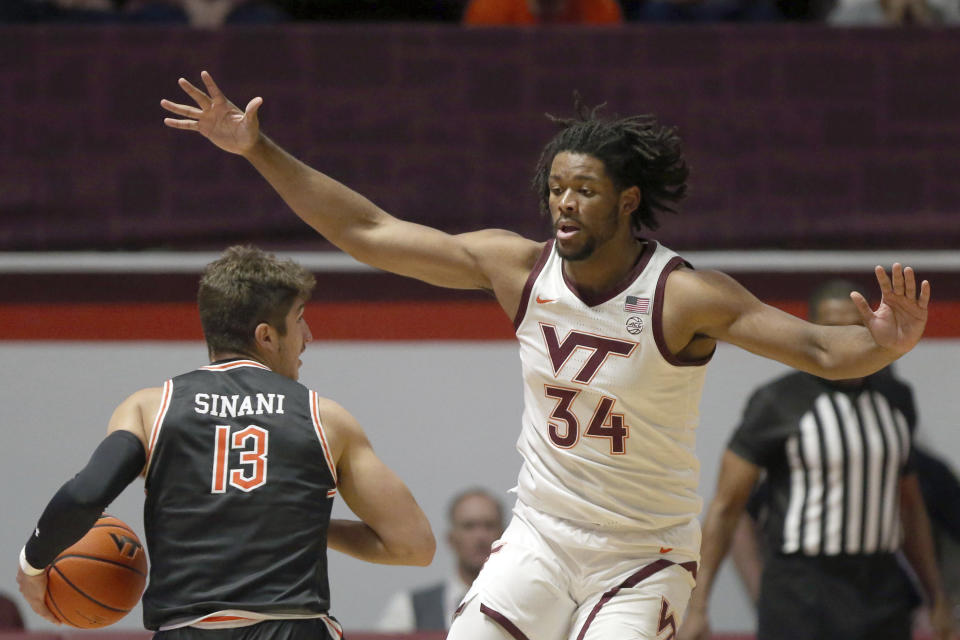 Campbell's Jasin Sinani (13) is defended by Virginia Tech's Mylyjael Poteat (34) during the first half of an NCAA college basketball game Wednesday, Nov. 15, 2023, in Blacksburg, Va. (Matt Gentry/The Roanoke Times via AP)