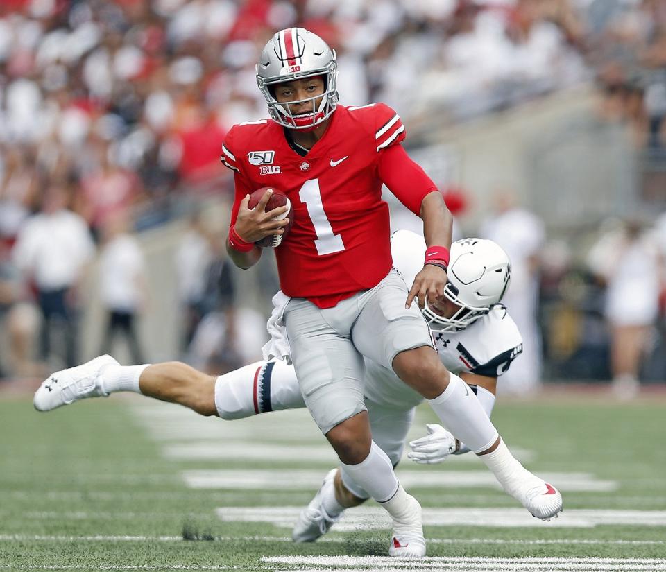 Ohio State Buckeyes quarterback Justin Fields (1) shakes off Cincinnati Bearcats linebacker Joel Dublanko (41) during the 1st quarter of their game at Ohio Stadium on September 7, 2019. The Buckeyes won the game 42-0 and have won every matchup with Cincinnati since 1900.