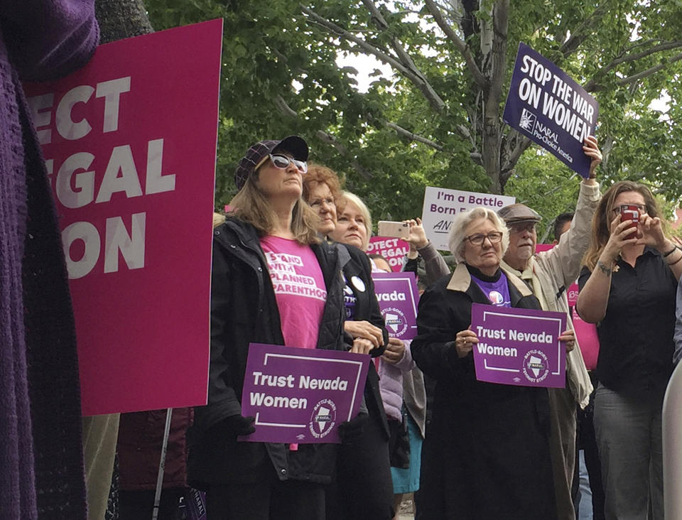 Supporters of a bill that would rewrite Nevada's abortion laws rally in front of the Legislature in Carson City, Nev., on Tuesday, May 21, 2019. Nevada lawmakers are bucking a national trend of restrictive abortion laws by voting to repeal requirements that physicians document a pregnant woman's marital status and tell her about the "emotional implications" of an abortion. Democrats in the Assembly passed the bill in largely party-line vote on Tuesday, the same day protesters across the country decried actions in other statehouses that toughen abortion laws. (AP Photo/Ryan Tarinelli)