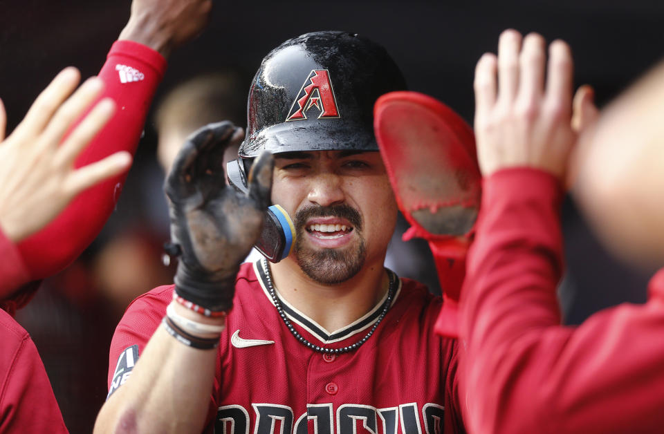 Arizona Diamondbacks' Corbin Carroll returns to the dugout after scoring a run in the first inning during a baseball game against the New York Yankees, Sunday, Sept. 24, 2023, in New York. (AP Photo/John Munson)