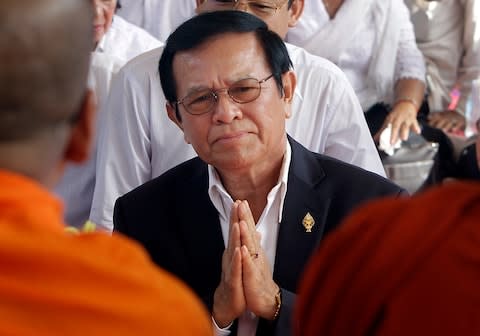 In this March 30, 2017, file photo, leader of the opposition Cambodia National Rescue Party Kem Sokha prays during a Buddhist ceremony to mark the 20th anniversary of the attack on anti-government protesters in 1997, in Phnom Penh, Cambodia - Credit:  AP