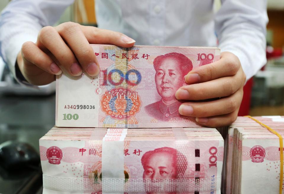 On the rise? An employee counts 100-yuan notes at a bank in Nantong in China’s eastern Jiangsu province on July 23, 2018. Photo: AFP/Getty Images