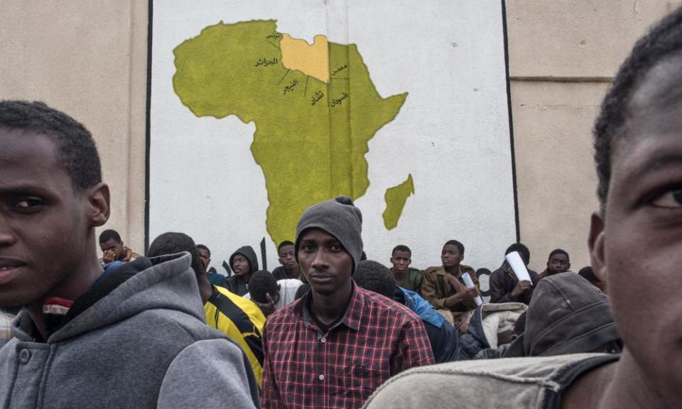 Refugees wait at the Tariq al-Matar detention centre, on the outskirts of Tripoli