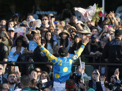 Victor Espinoza reacts to the crowd after guiding American Pharoah to win the Triple Crown. (AP)