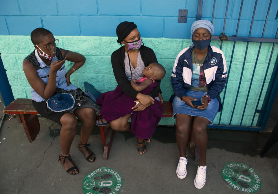 FILE - In this Thursday, Dec. 24, 2020 file photo, long-distance travellers wait for results after being tested for COVID-19 at a mobile clinic at a taxi rank at Johannesburg's main railway station. As a result of holiday gatherings, African officials warn of a resurgence of COVID-19 on the continent and urge increased testing to combat it. The level of testing across Africa is considerably less than what health experts say is needed to effectively control the spread of the disease. (AP Photo/Denis Farrell, File)