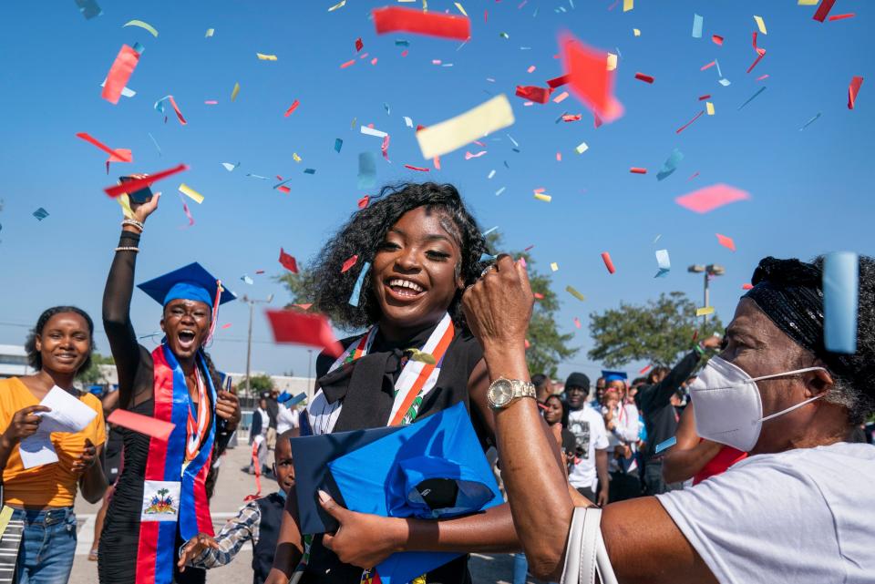 Palm Beach Gardens High School senior Aeriel Brutus is showered in confetti to celebrate her graduation with friends and family at the South Florida Fairgrounds on May 18, 2022.