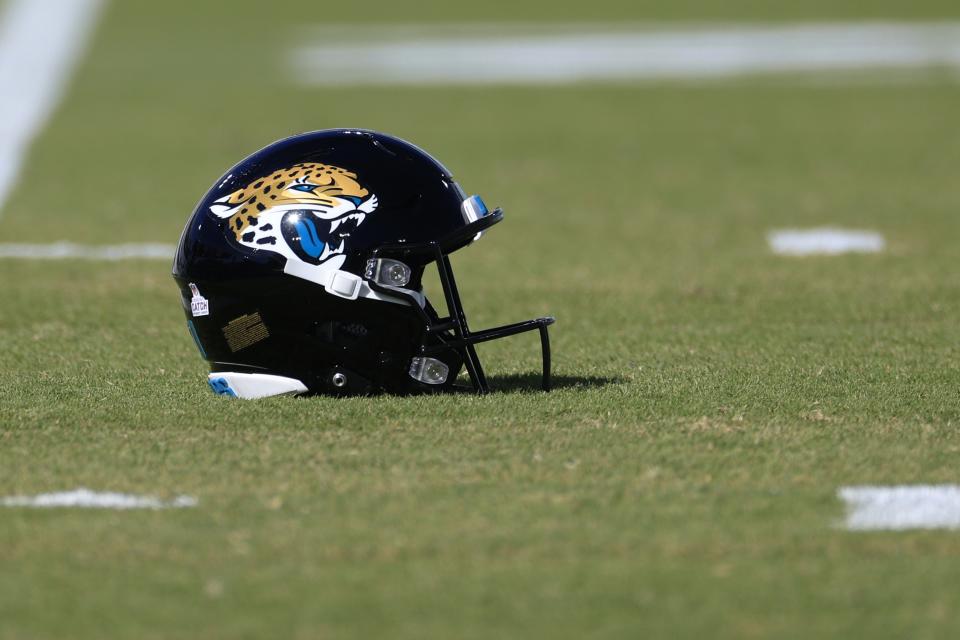 A Jacksonville Jaguars football helmet lies on the field before of a regular season NFL football matchup against New York Giants Sunday, Oct. 23, 2022 at TIAA Bank Field in Jacksonville. [Corey Perrine/Florida Times-Union]