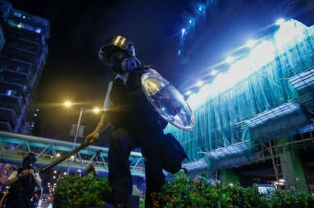 A police officer advances during clashes with an anti-extradition bill protester in Sham Shui Po in Hong Kong