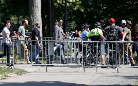 Speakers depart after cutting short their rally - Credit: AP