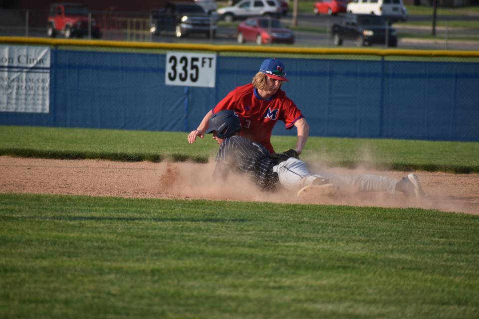 Martinsville's Levi Cunningham tags Decatur Central's Kaden Barr out as he attempts to slide to second during the Artesians' game with the Hawks on May 10, 2022.