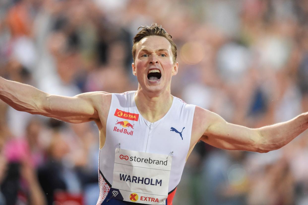 Norway's Karsten Warholm reacts after winning and breaking the world record during the 400m hurdles men final at the Diamond League track and field meeting in Oslo on July 1, 2021. - Norway's Karsten Warholm fired out a shot at potential Tokyo Olympic rivals when he shattered the long-standing 400m hurdles world record at Diamond League meet in Oslo and warned he had 