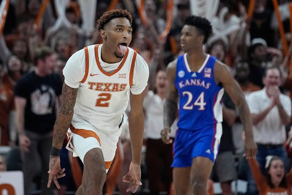 Then with Texas, Arterio Morris celebrates scoring a basket against Kansas this past season during a game in Austin on March 4. After the season, Morris decided to transfer to Kansas.