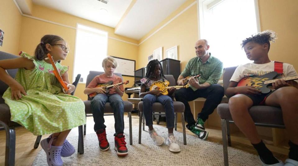 PHOTO: Brian Calhoun teaches kids how to play a TinkerTar. (ABC News)